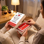 Hands opening an A Little Closer box by candlelight
