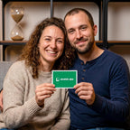 Smiling couple holding a 20-Minute Reset card