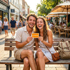 Laughing couple holding a Summer Starts Here card outdoors