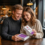 Couple opening an Under $25 Tonight box at a cafe table